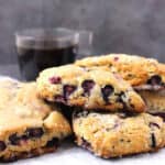 Best blueberry scones with maple glaze served with cup of coffee.