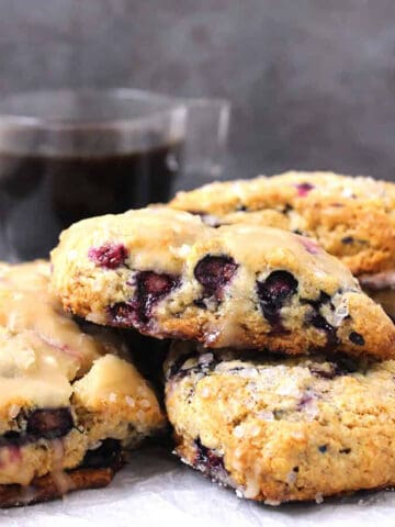 Best blueberry scones with maple glaze served with cup of coffee.