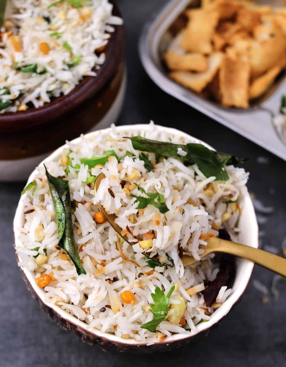 Spoonful of best coconut rice made using white basmati rice and fresh coconut flakes. 