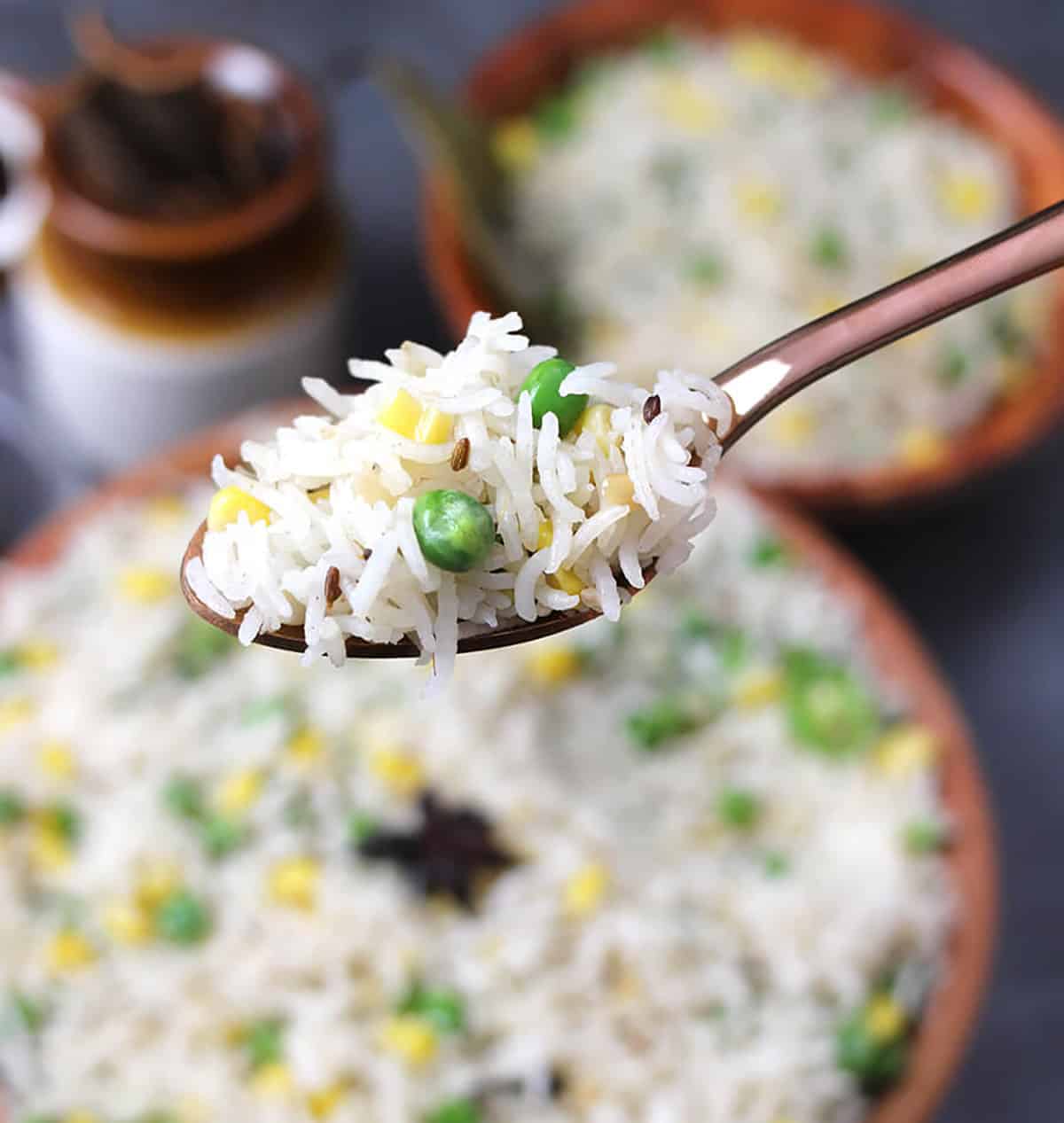 holding spoon of basmati ghee rice cooked to perfection