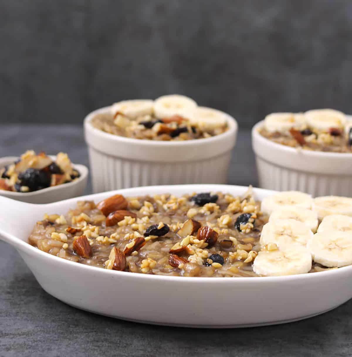 moong dal khichdi, temple style traditional recipe garnished with bananas, almonds, cashews, raisins 