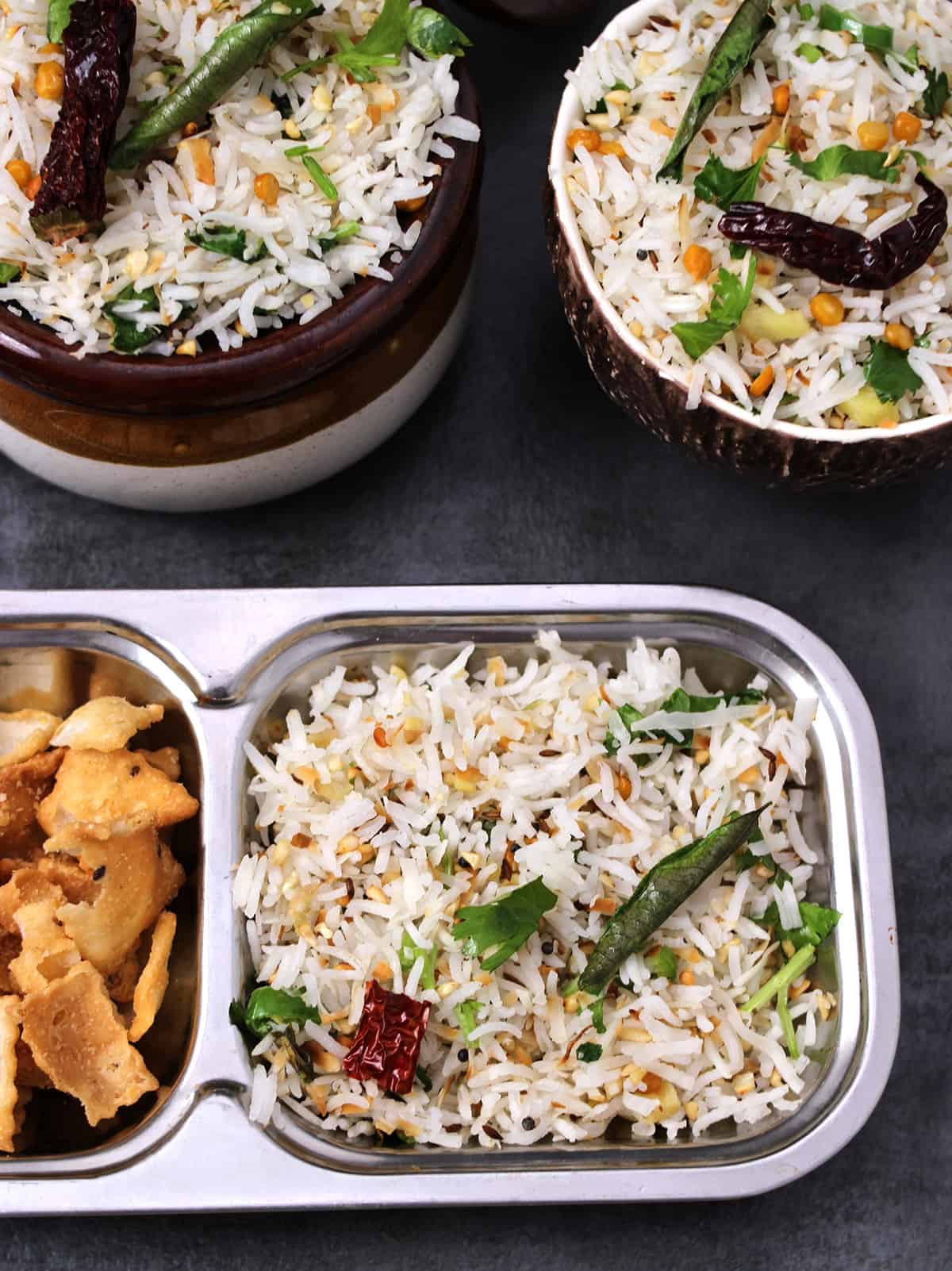 Easy coconut rice (kobbari annam prasadam) served in a plate with fryums. 