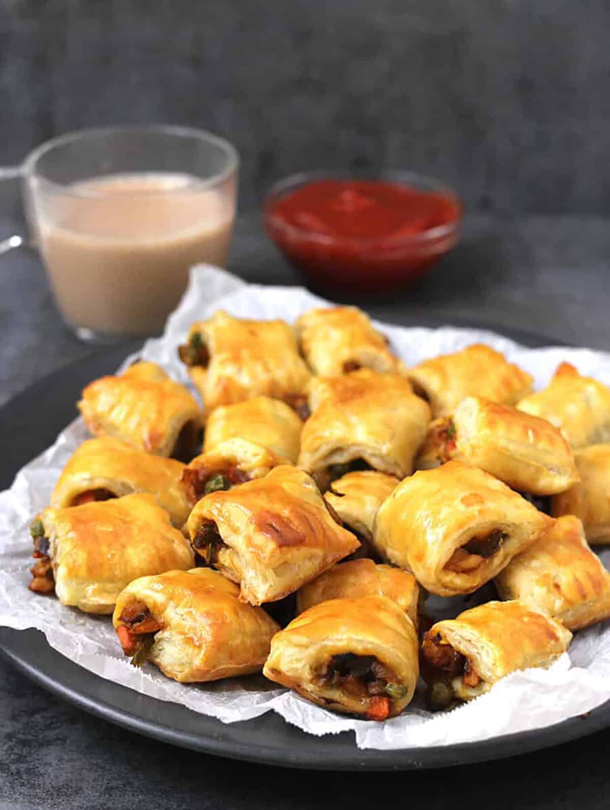 Bakery-style Indian veg puffs/curry puff pastry bites served with hot tea (chai) & tomato ketchup. 