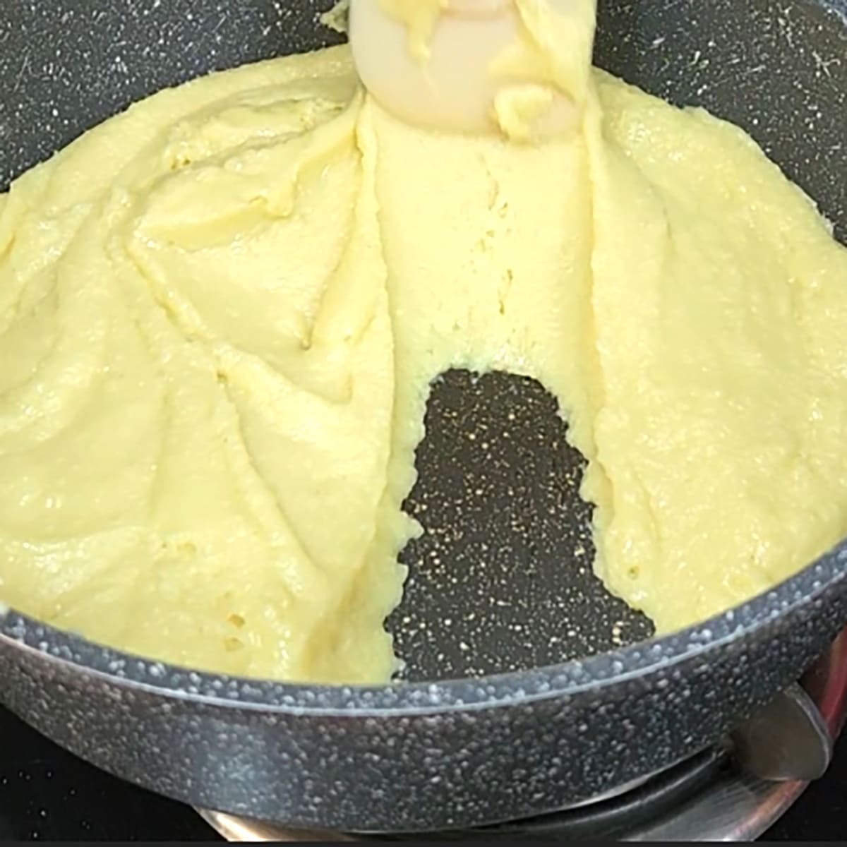 Stir until ghee leaves side of pan and barfi is ready to set. 