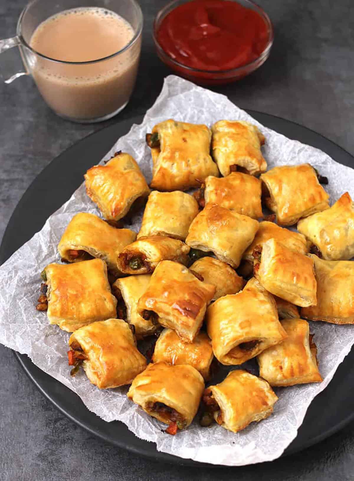 Indian veg puffs (vegetarian curry puff) using puff pastry served with hot masala chai & ketchup.