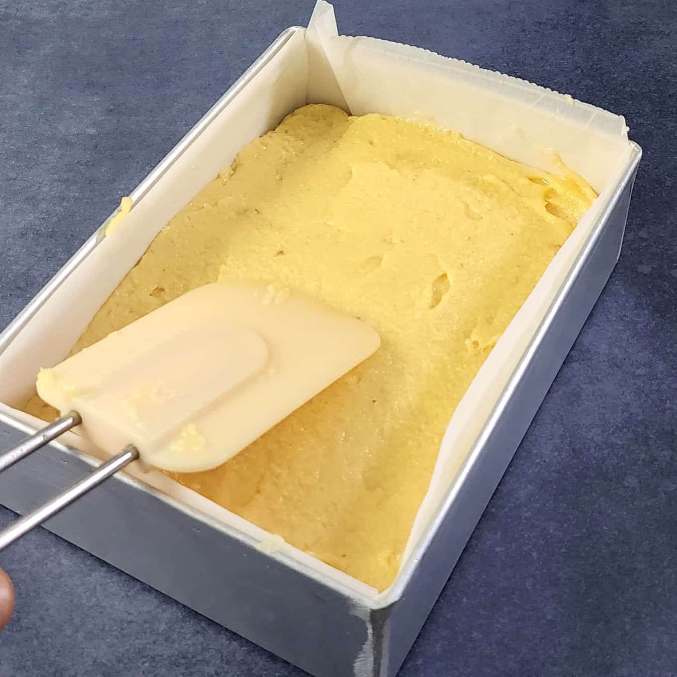 Smoothen burfi with back of spoon or spatula.