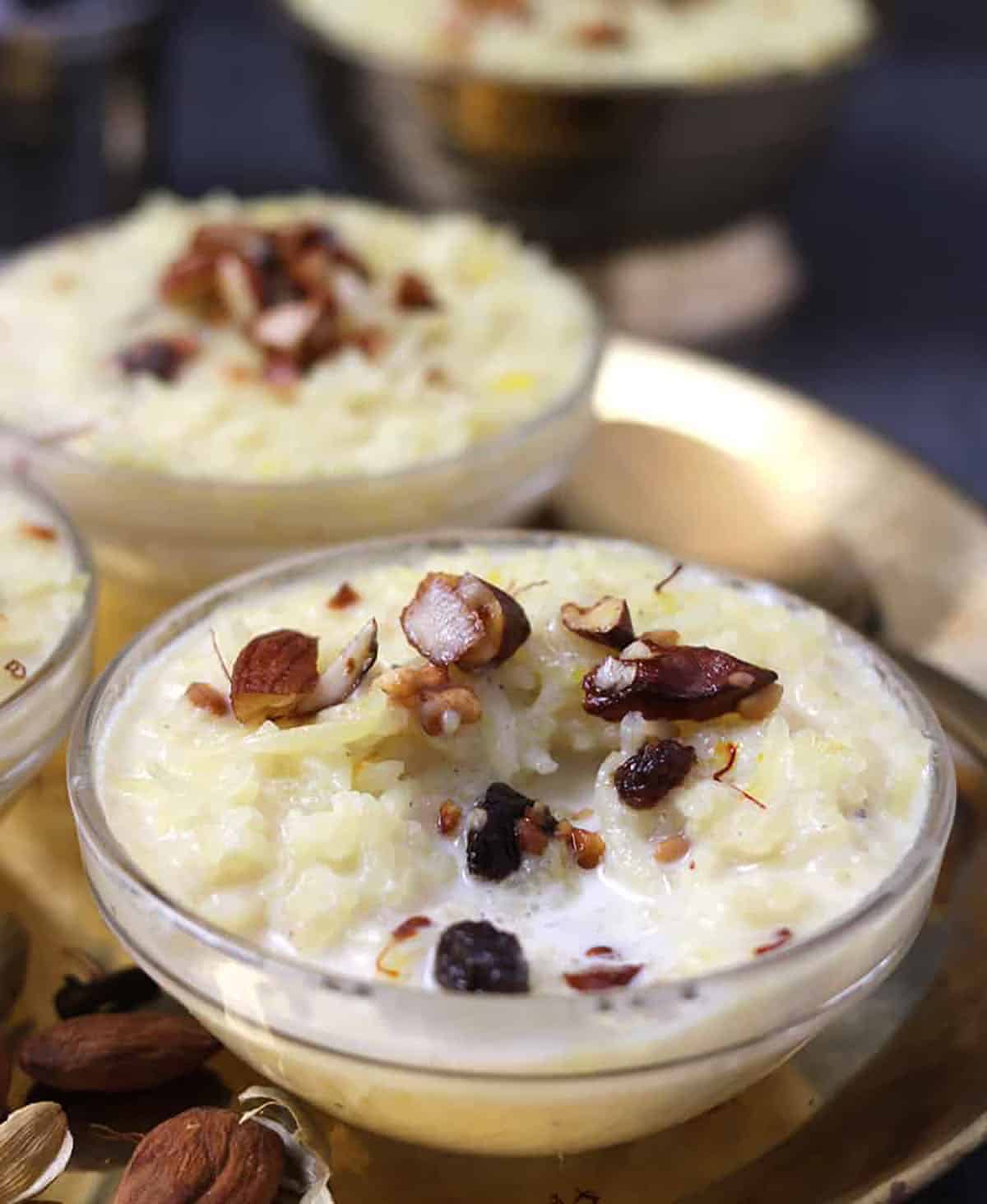 close up view of thick creamy doodhpak, rice kheer in glass bowl 