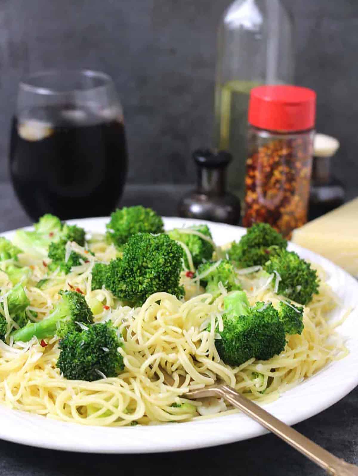 Quick angel hair pasta with garlic, broccoli, and oil for dinner or any vegetarian meal.  