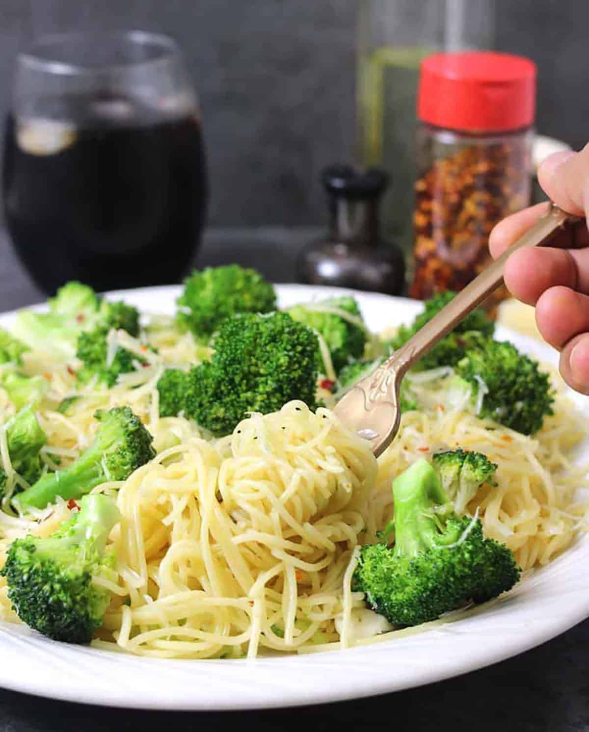 Simple broccoli pasta or Angel hair pasta with garlic and broccoli on a serving plate. 