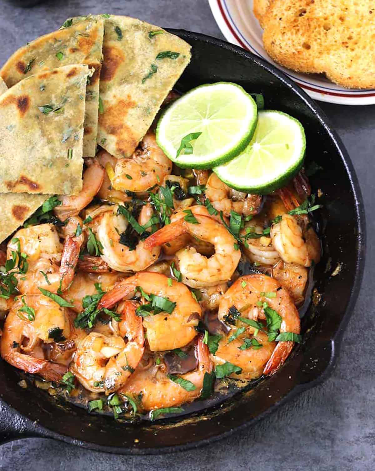 Easy & quick garlic butter shrimp (garlic prawns) in a cast iron pan served with avocado flatbread. 