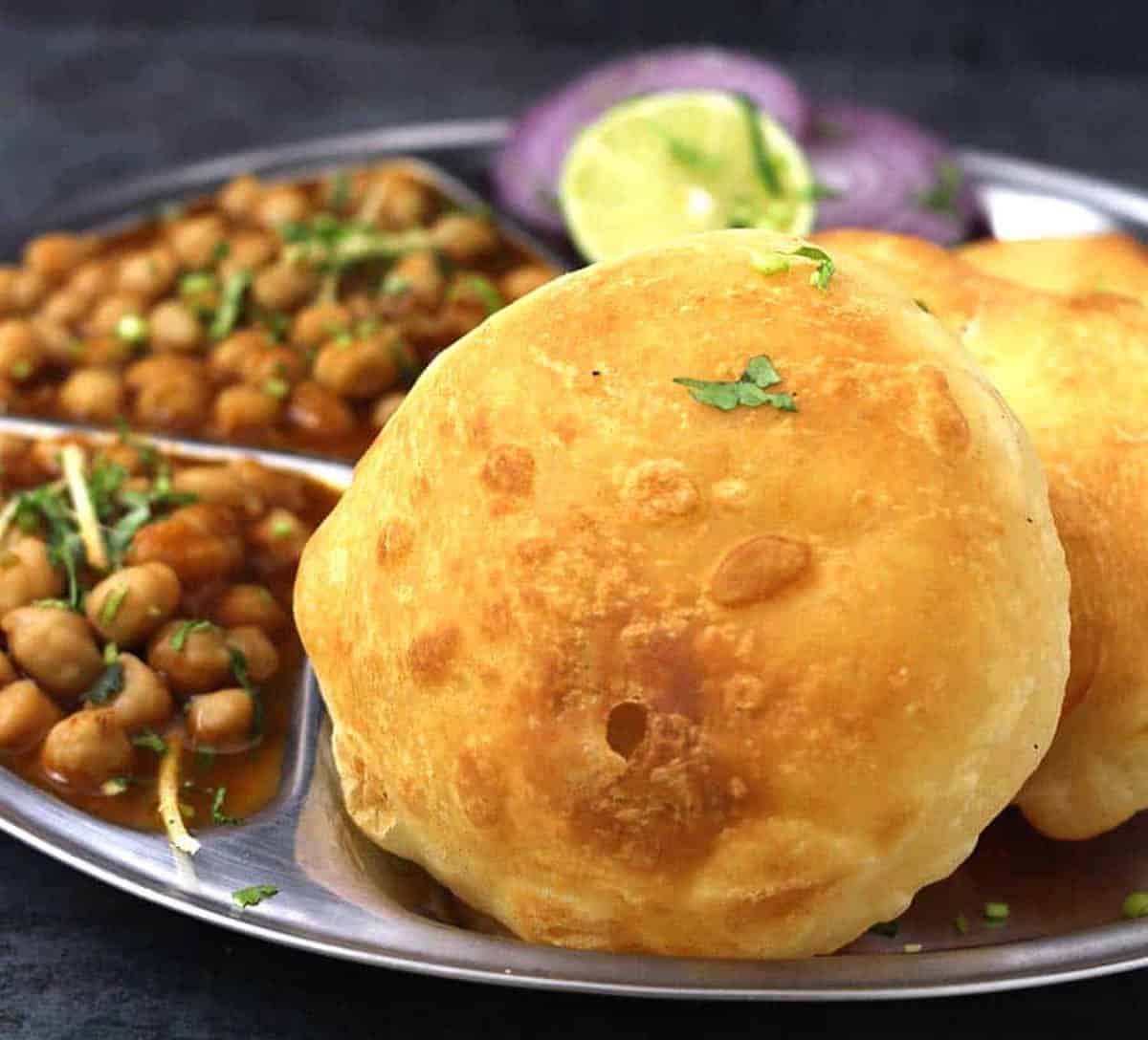 Perfectly puffed up and crispy homemade bhatura (bhature) - Indian flatbread recipe without yeast.