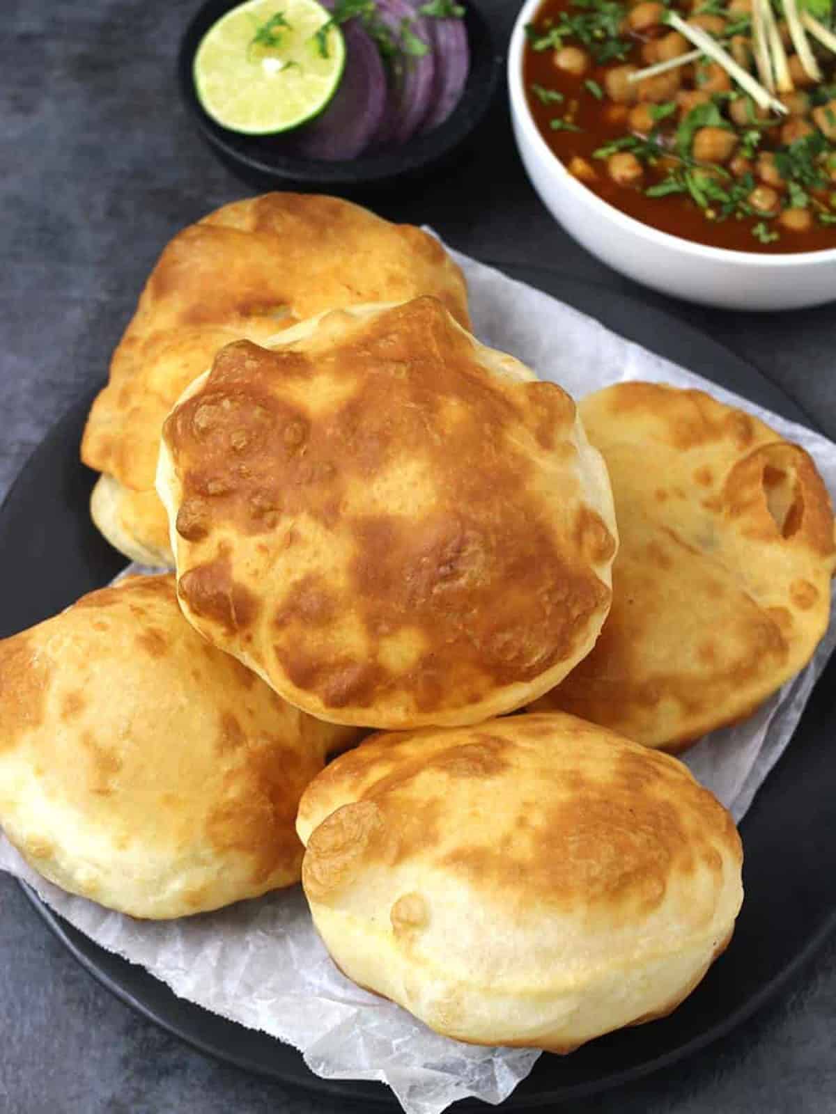 Fluffy & crispy fried bhature (bhatura) made with flour(maida), yogurt, baking soda, & baking powder.