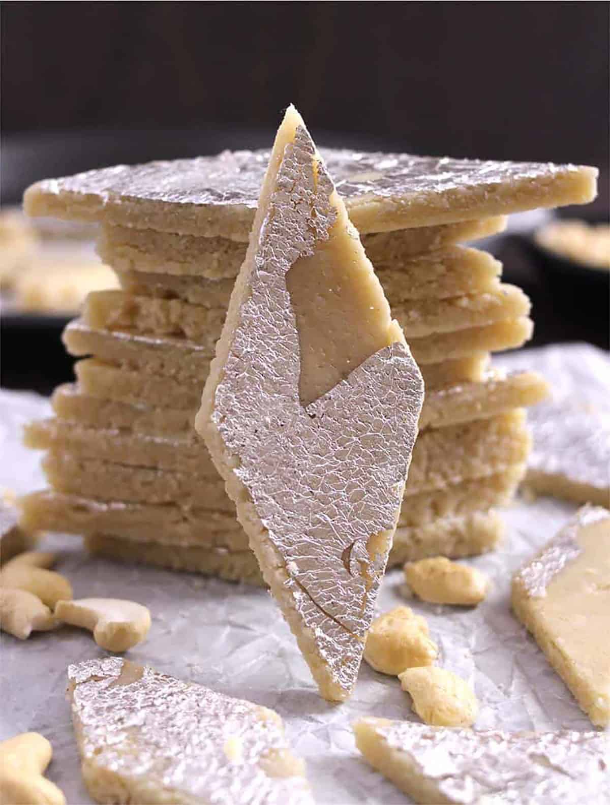 Best Halwai Style Kaju Katli (Indian Kaju Barfi Slices) One burfi focused and remaining stacked.
