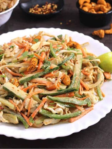 best crunchy thai salad on a serving plate with spicy cashew dressing.