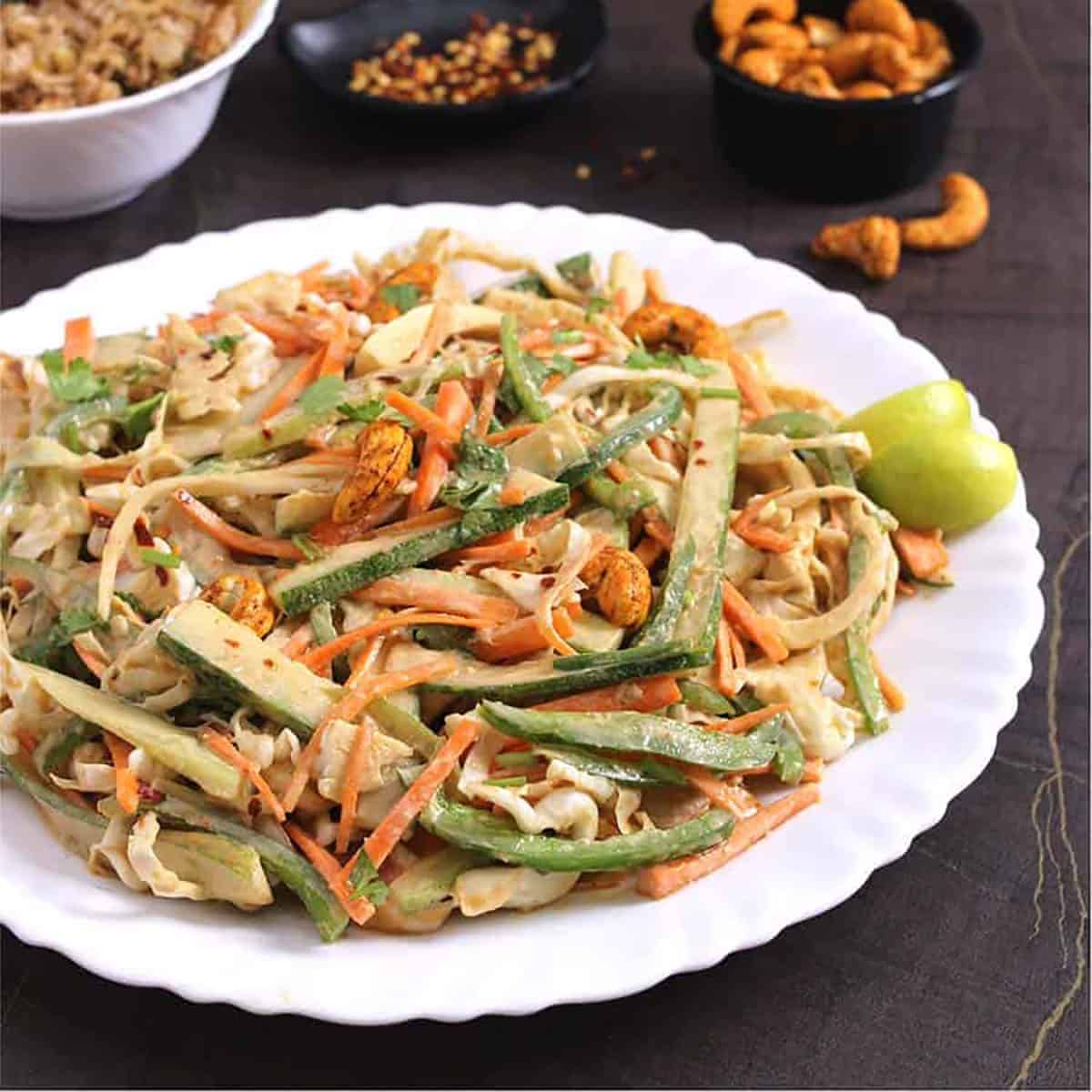 best crunchy thai salad on a serving plate with spicy cashew dressing.