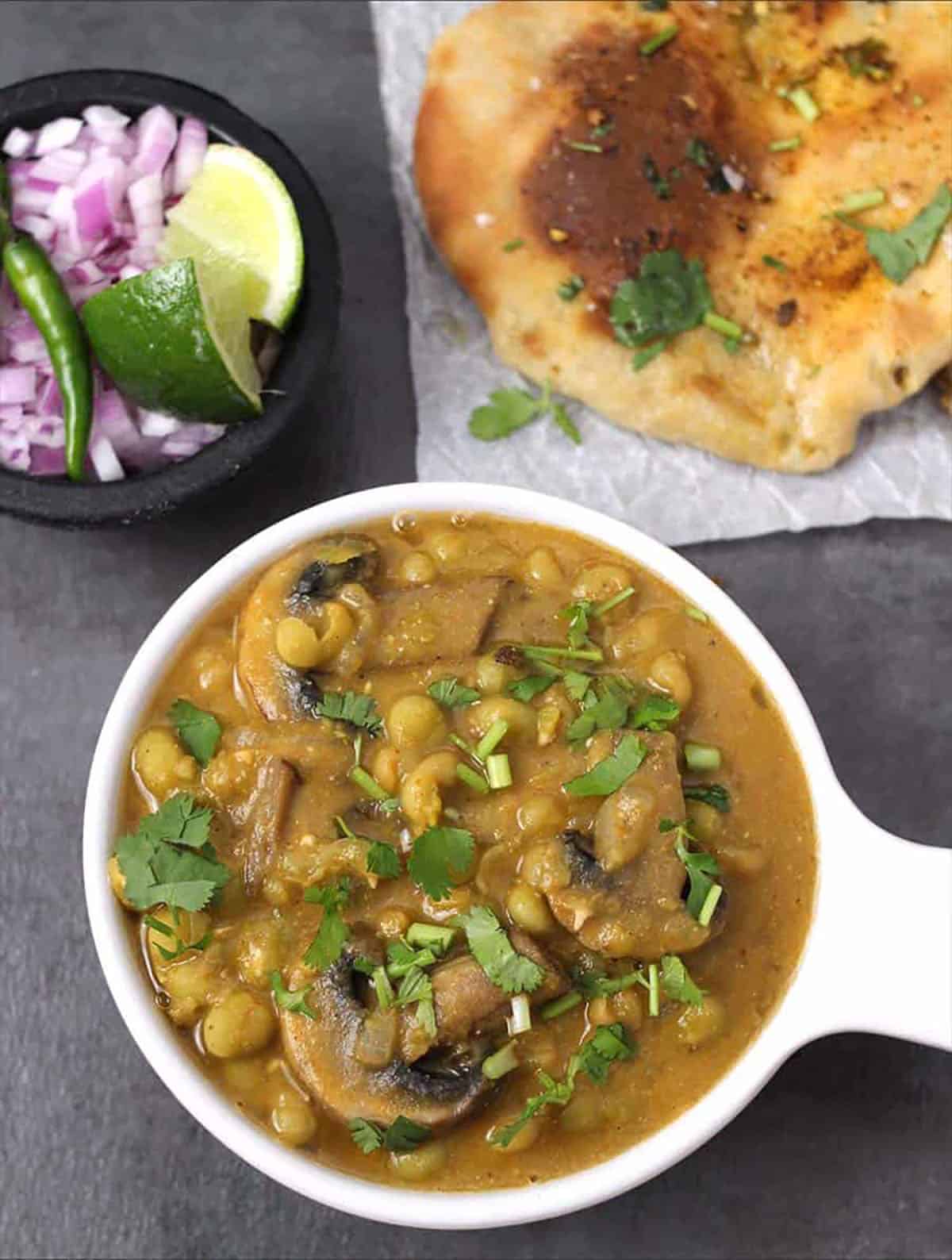 Mushroom peas masala or Indian dhaba style matar mushroom served with amritsari kulcha. 