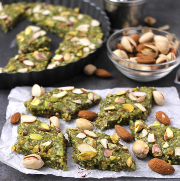 Badam Pista Barfi, prepared using crushed pistachios and topped with other nuts.