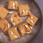 popular Indian besan burfi sweet with milk powder (besan ki barfi) garnished with almonds.