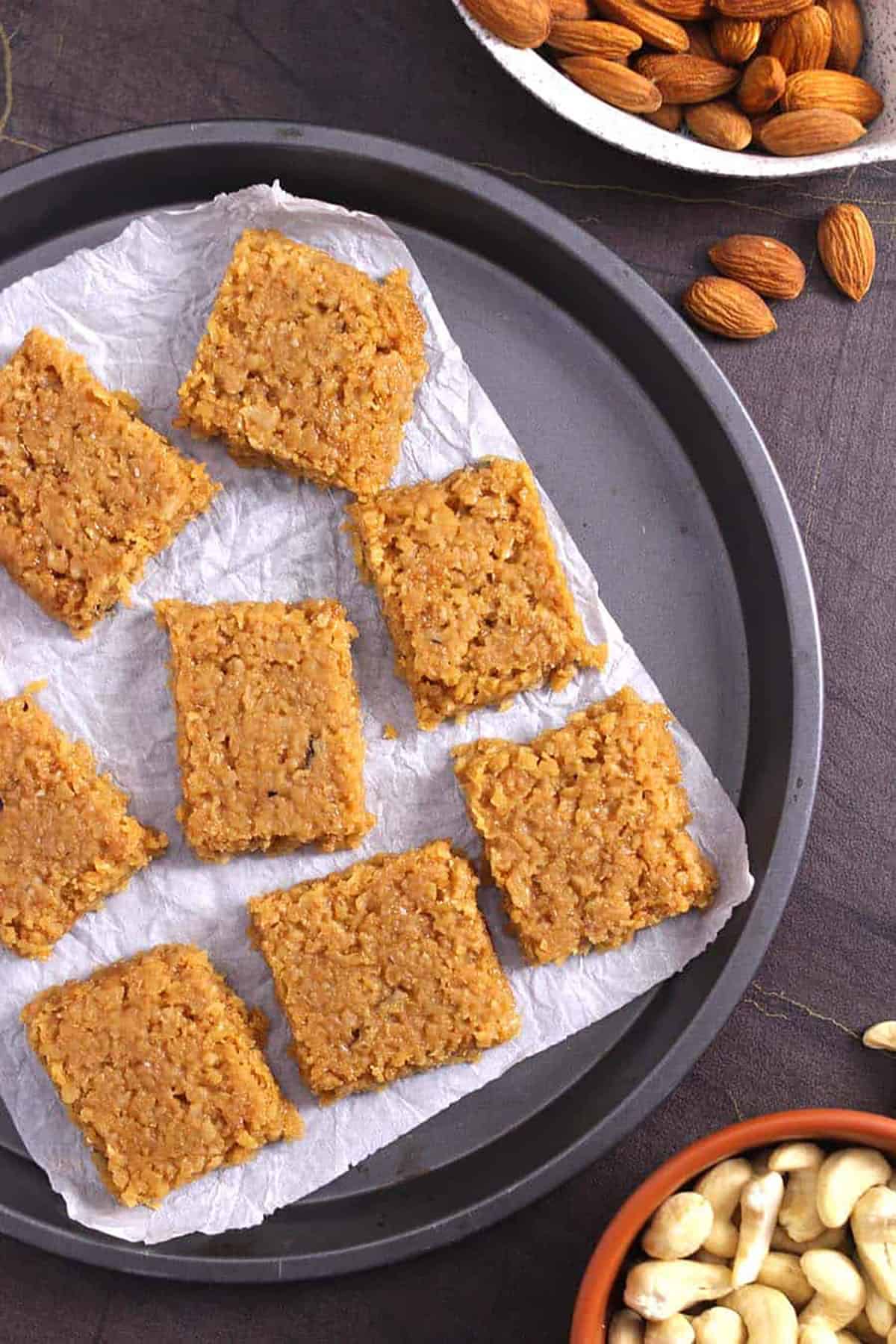 Best jaggery coconut burfi sweet on white parchment paper / Healthy Indian sweet