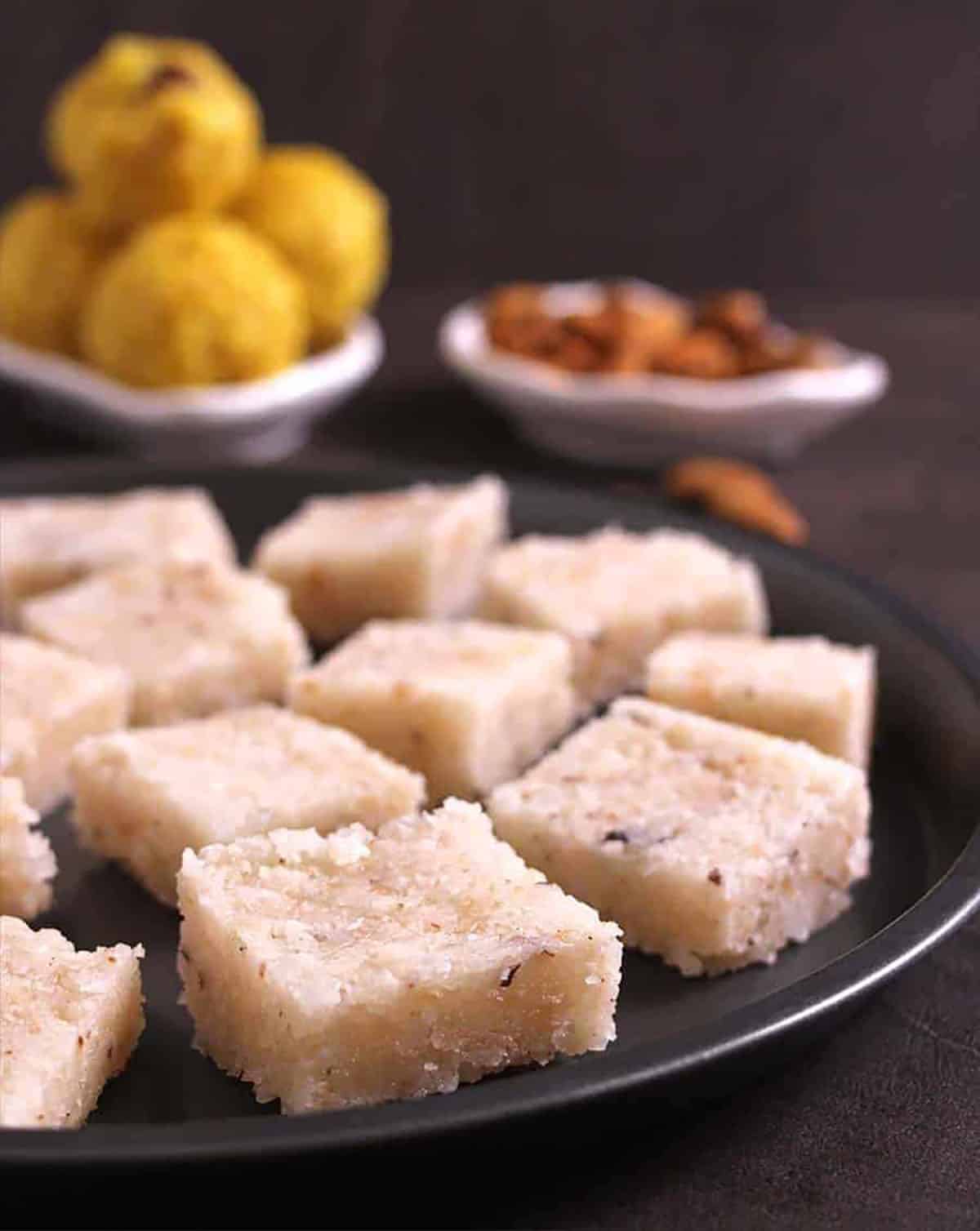 Melt in mouth Indian sweet coconut burfi or nariyal barfi recipe with motichoor ladoo in background
