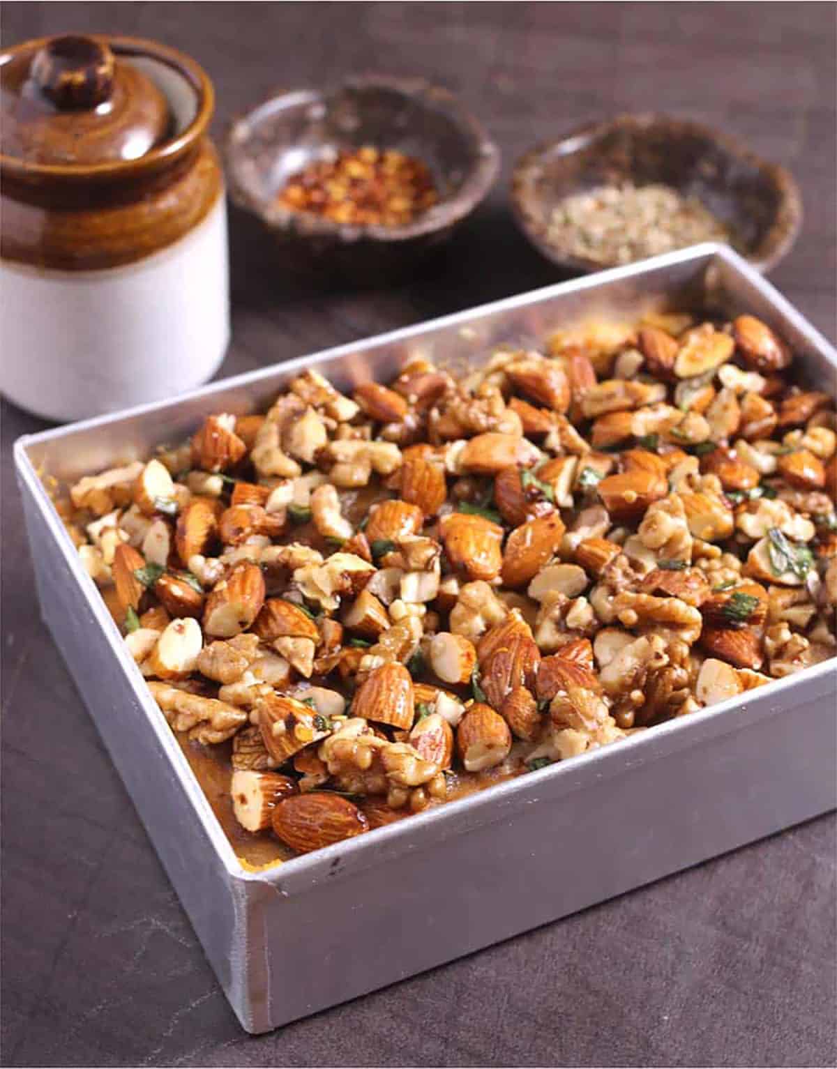 Sweet potato casserole on baking dish topped with almonds and walnuts 