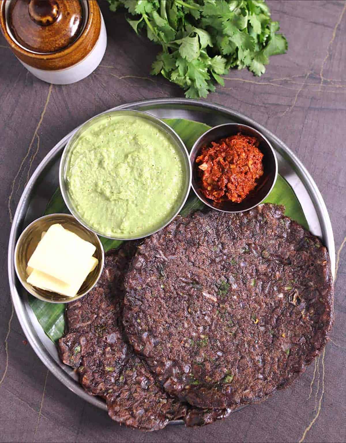 healthy ragi roti (nachni roti) served with spicy Indian chutney for breakfast, lunch and dinner.
