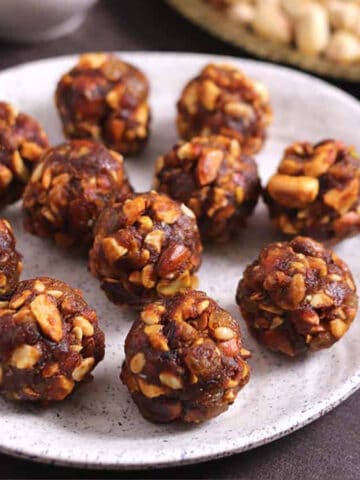 Easy energy balls with dates or dry fruit laddu (ladoo) on a plate.