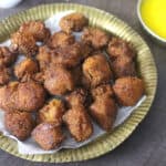 Ponsa mulik on a serving plate with desi ghee (Jackfruit fritters).