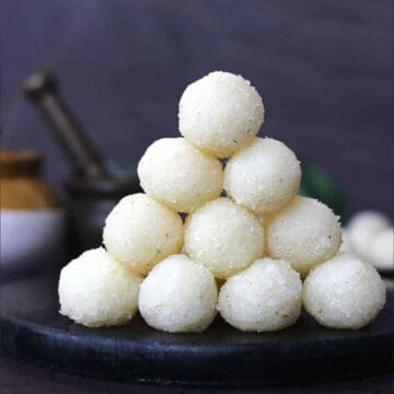 Best coconut ladoo (easy nariyal ke laddu), Stack of Indian coconut balls - coconut sweets.