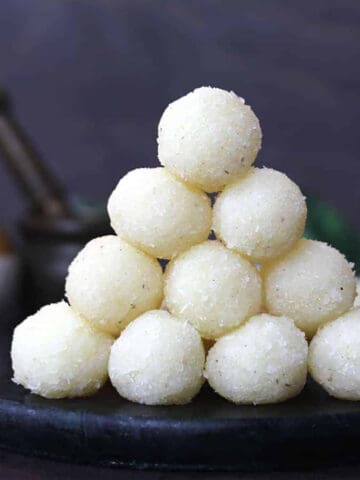 Best coconut ladoo (easy nariyal ke laddu), Stack of Indian coconut balls - coconut sweets.