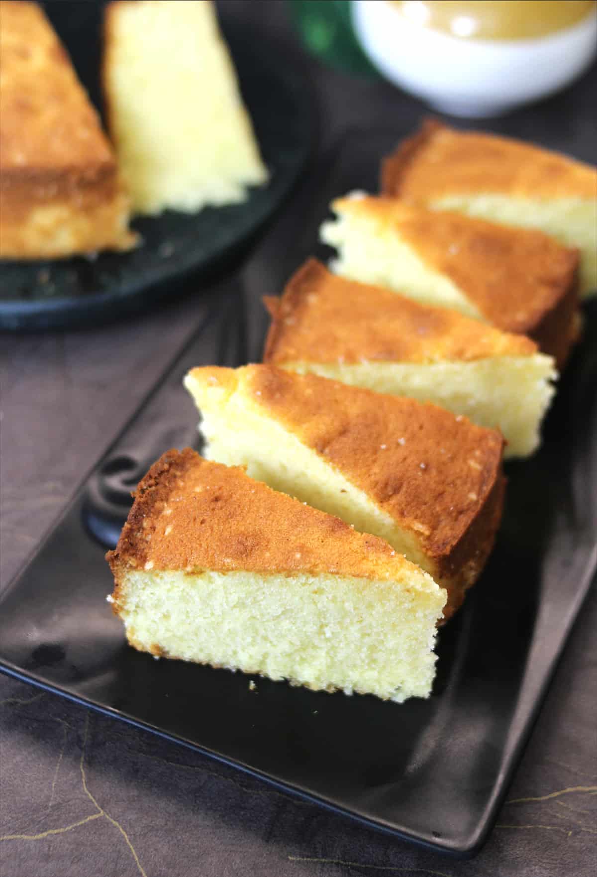 Butter cake or moist ghee cake slices on black plate ready to serve