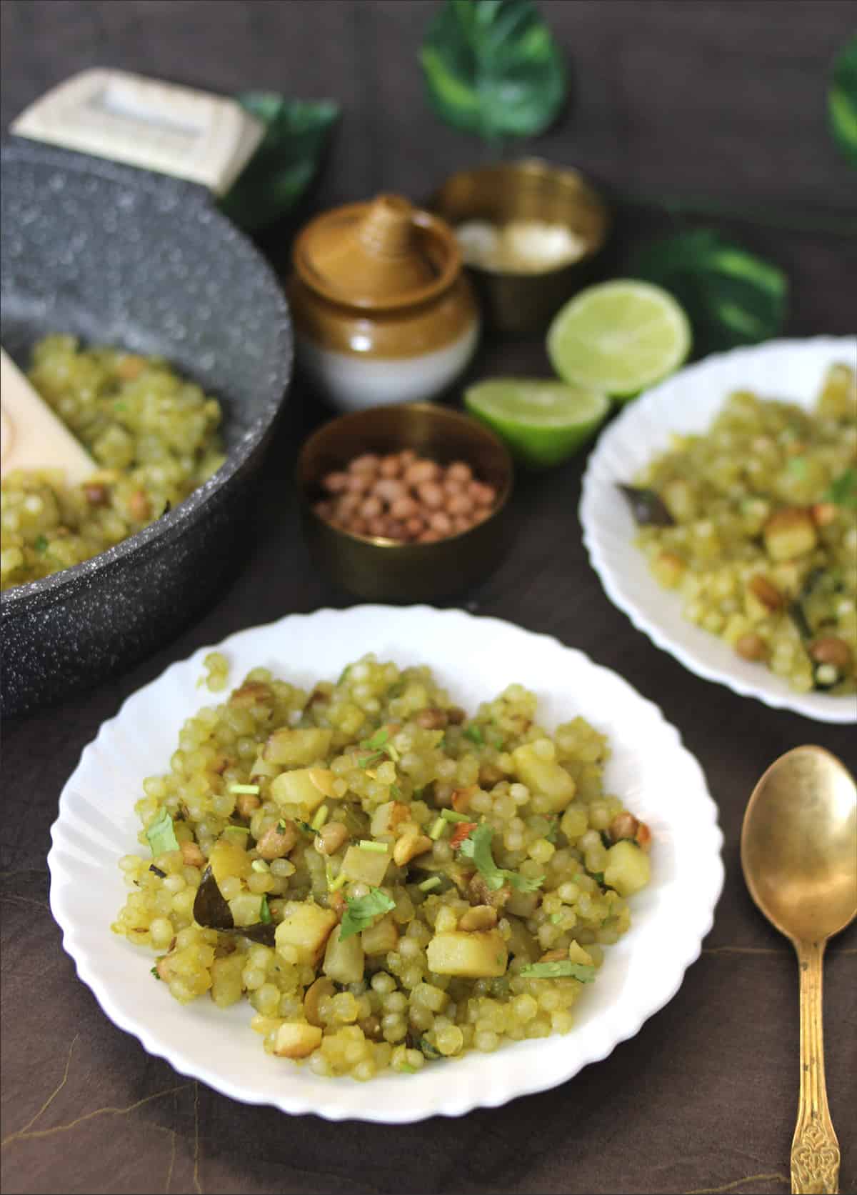 Best & easy sabudana khichdi served on two white plates with golden spoon