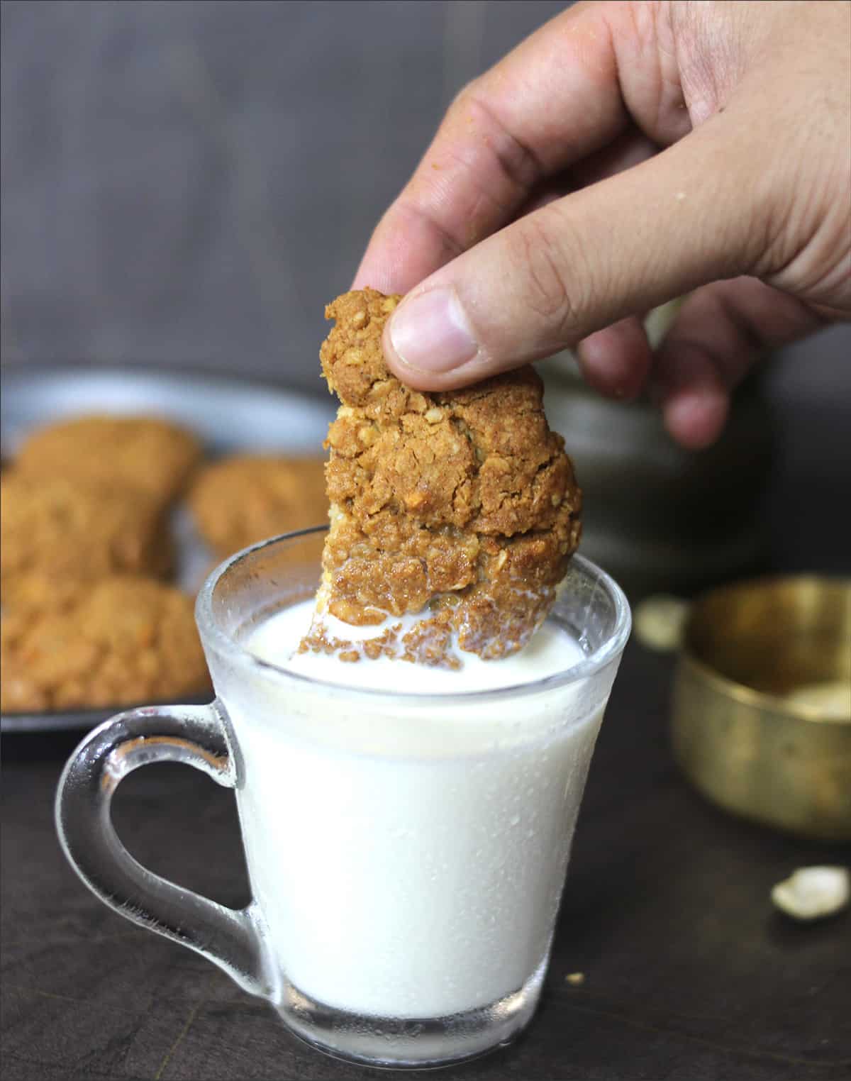 Whole wheat oatmeal jaggery cookies dipped in milk