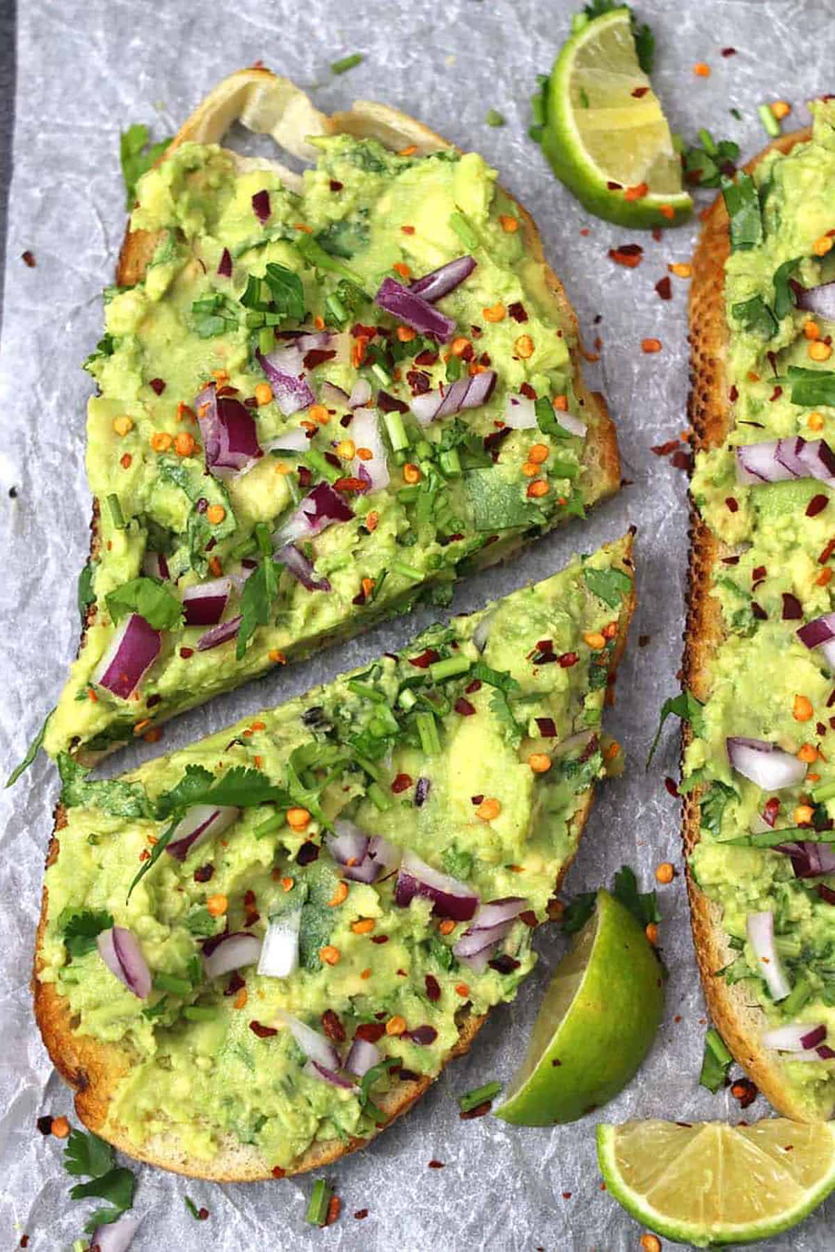 Butter fruit toasts cut into half and topped with red pepper flakes.