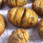 Top view of easy Hasselback Potatoes flavored using herbed garlic butter.