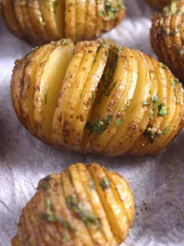 Top view of easy Hasselback Potatoes flavored using herbed garlic butter.