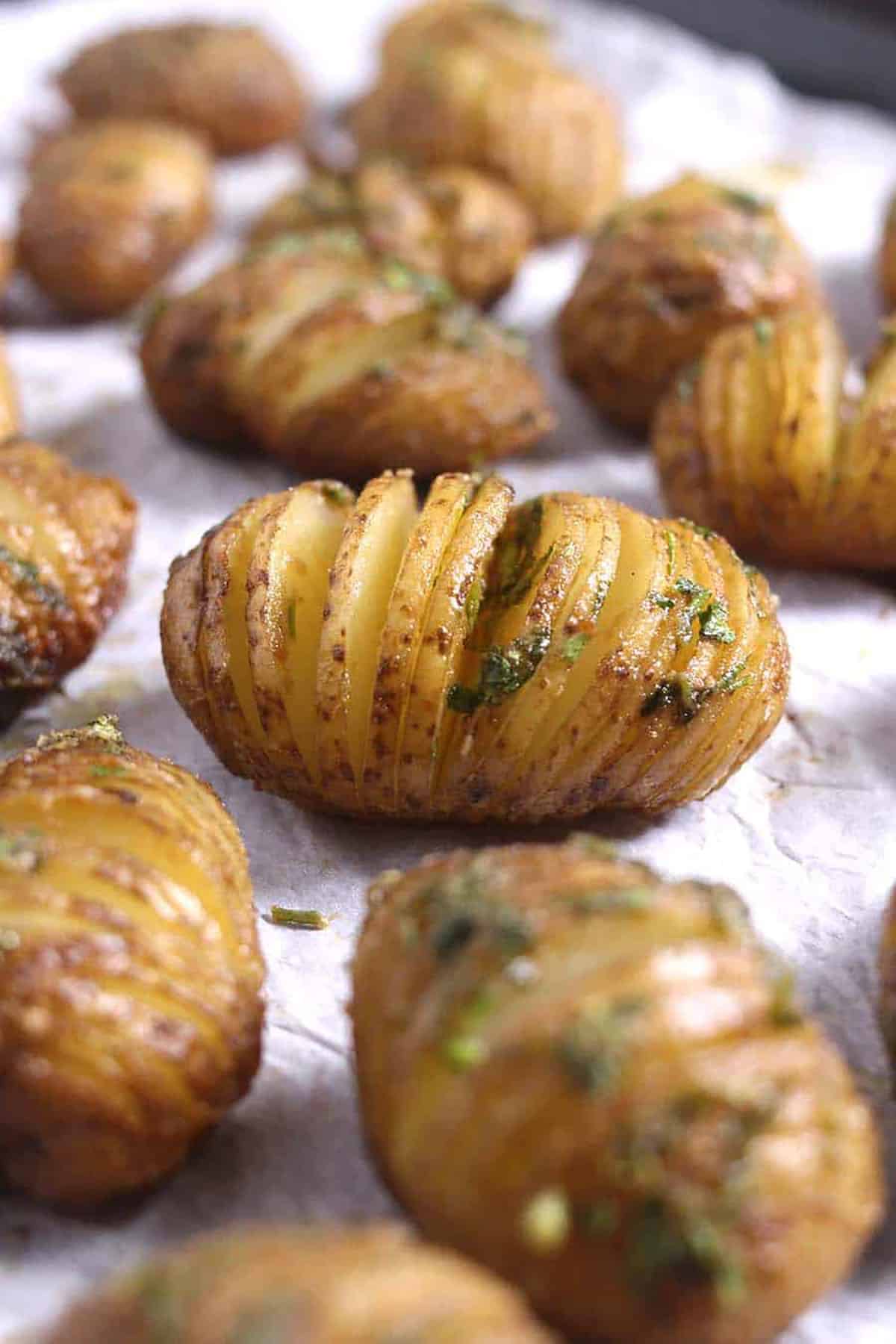 Front view of creamy and delicious Hasselback Potatoes in a baking pan.