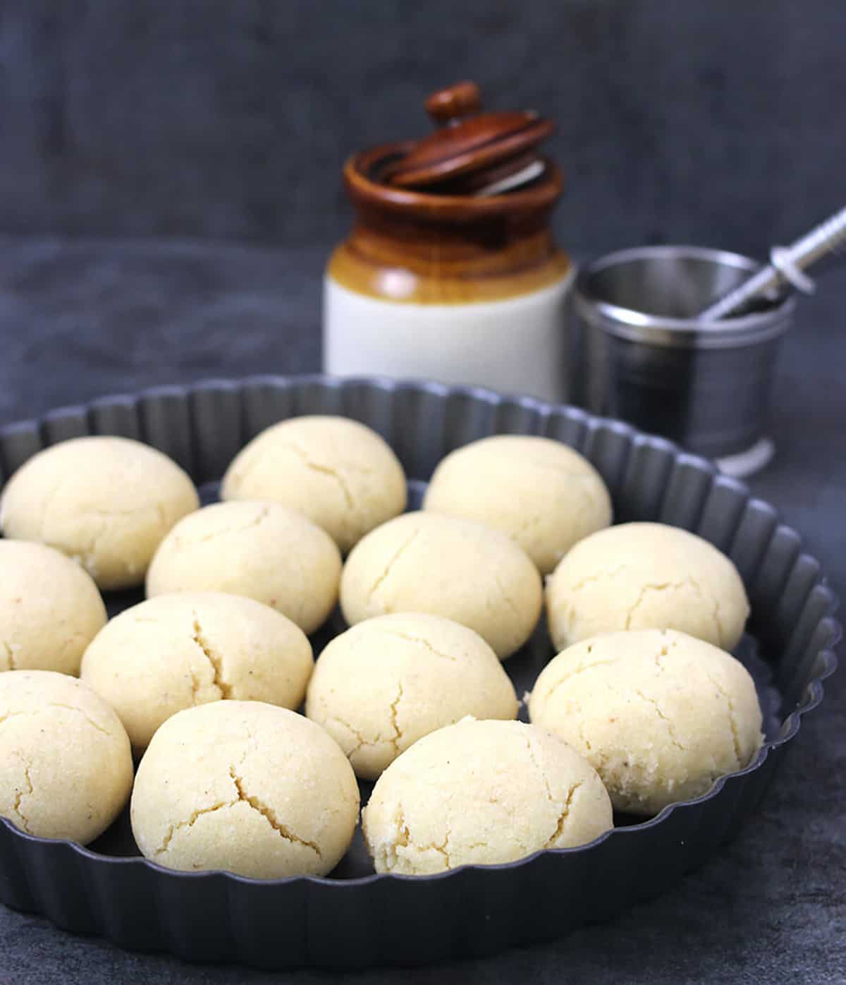 Delicious eggless and vegan cookies served in a black plate. These are similar to pecan sandies, and are called butter biscuits or nankhatai.
