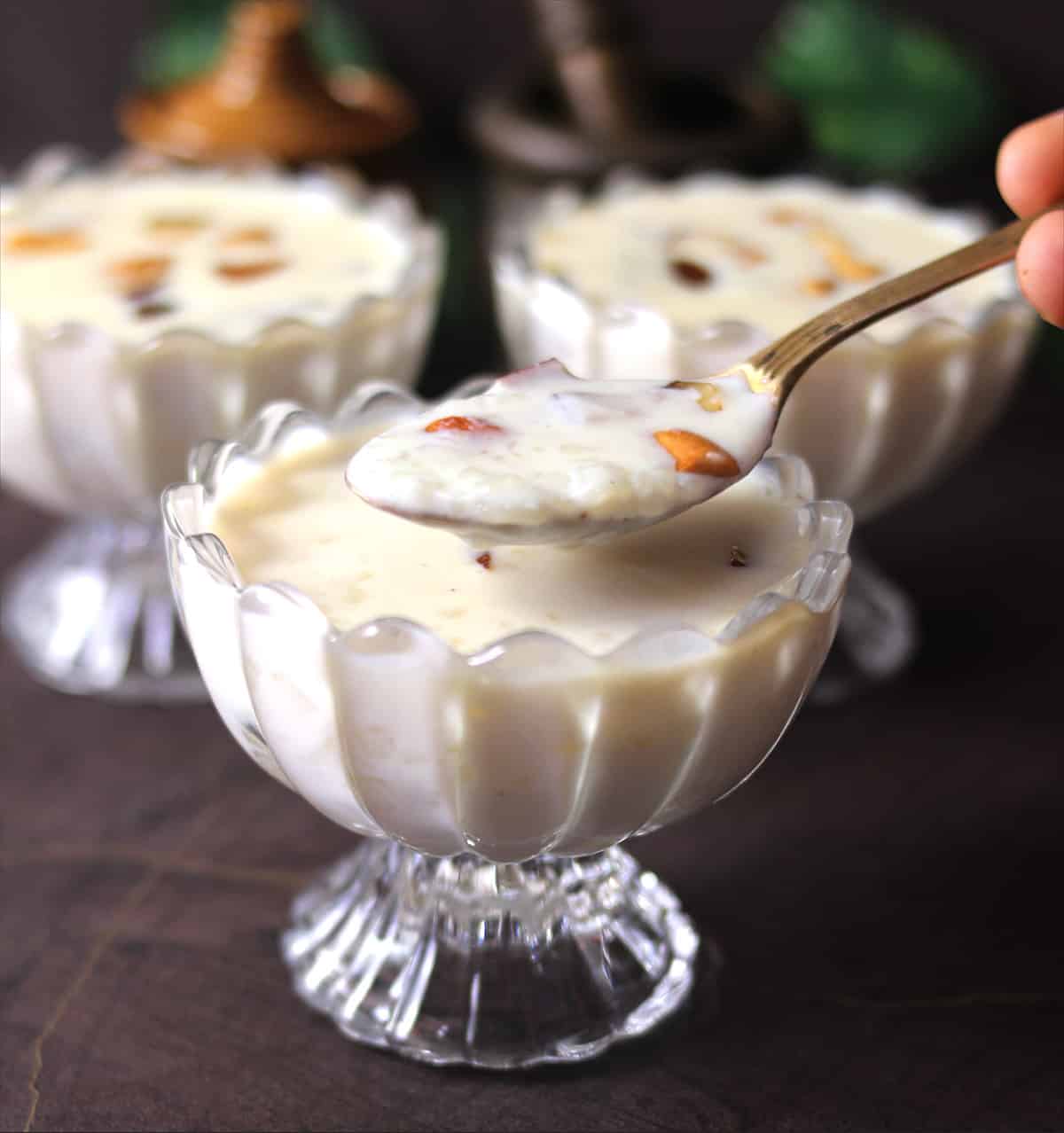 Popular South Indian style kheer or Payasam for onam, navratri, diwali, holding in a spoon