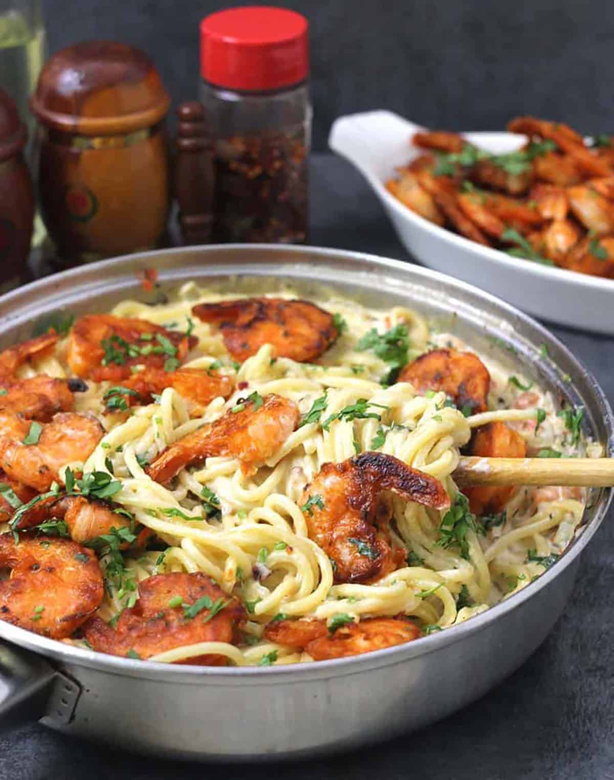 Best and Easy Shrimp Scampi Pasta served in a pan. A ladle of pasta is about to be served,