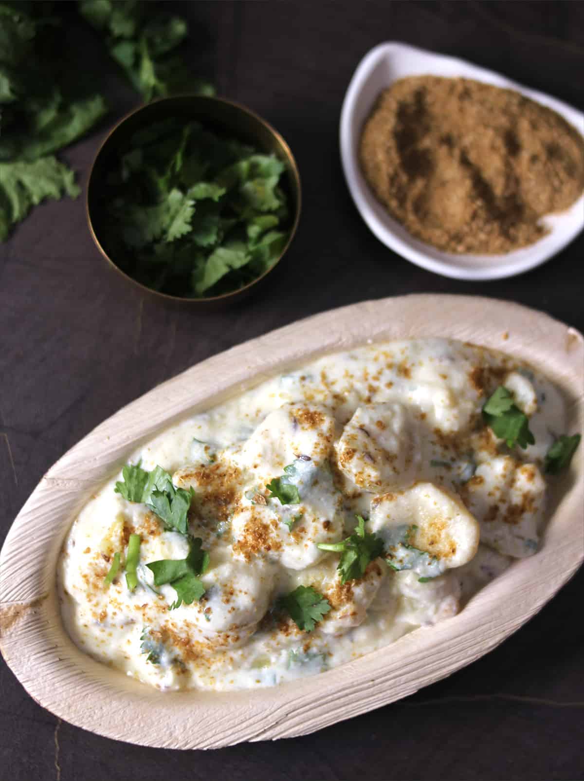 Top view of dahi aloo batate gojju or Indian recipes with curd