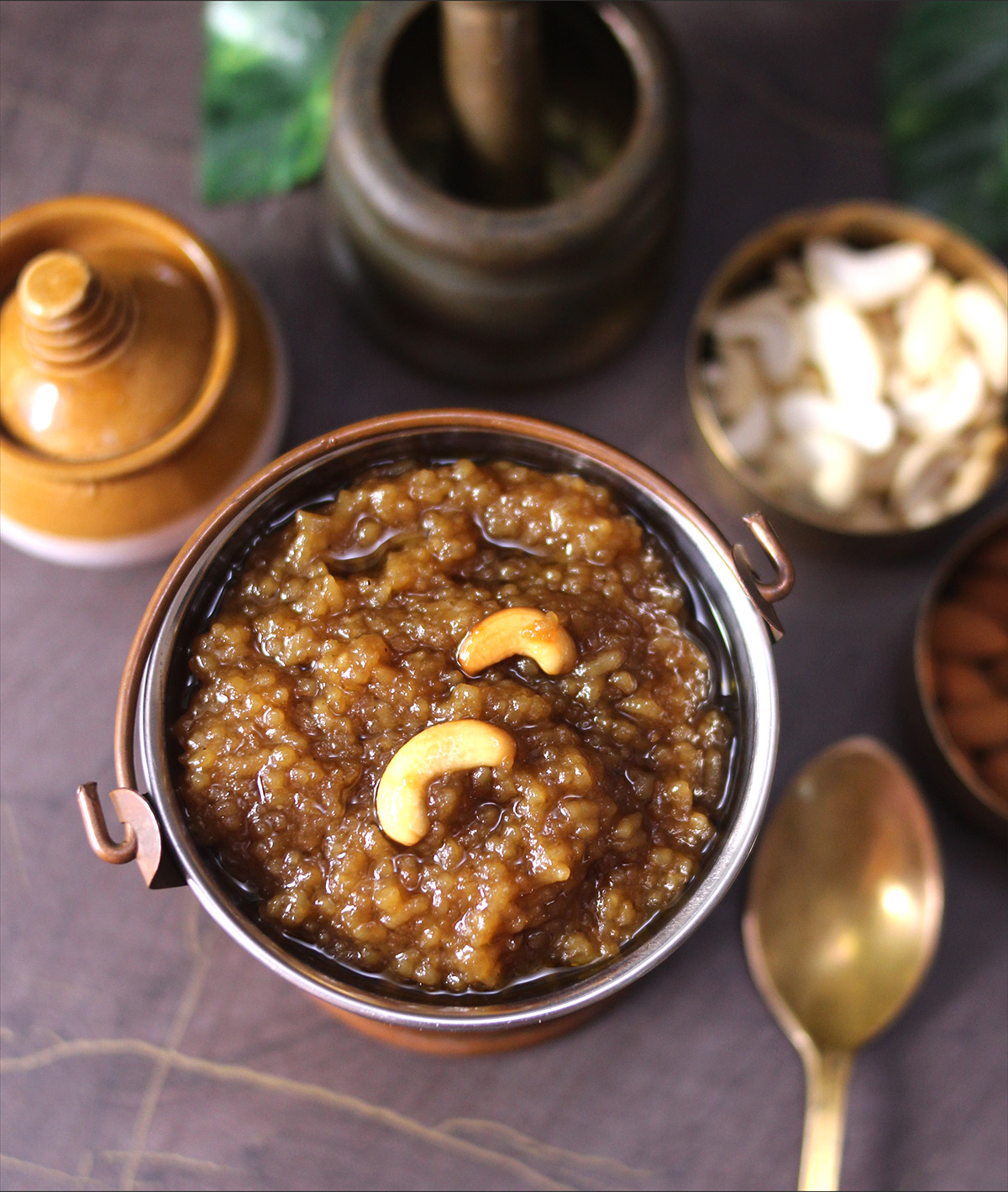 Top view of chakkara pongal or sweet khichdi, rice kheer made with jaggery served in copper bucket
