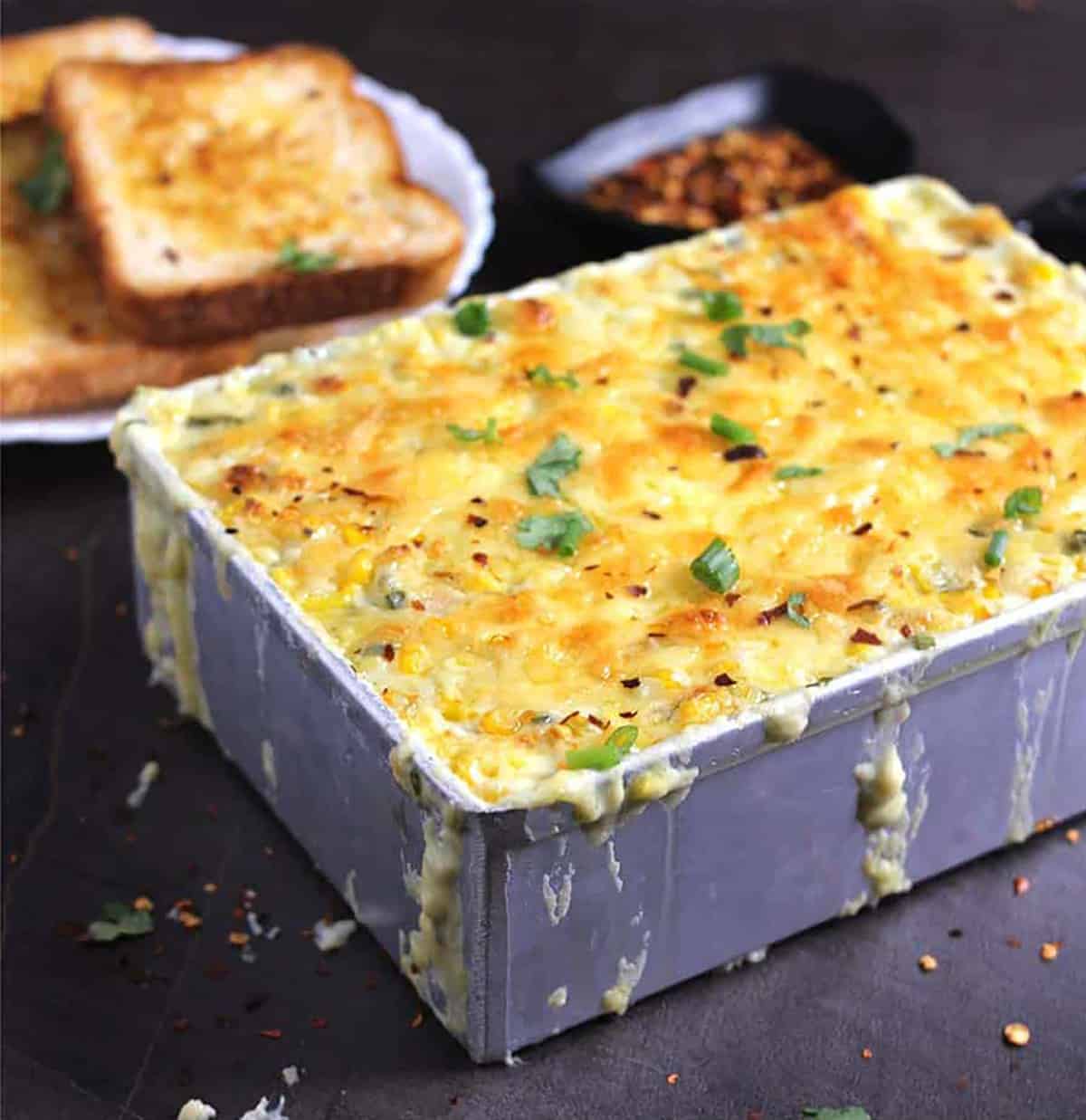 cheesy corn casserole with bubbly cheese topping right out of the oven.