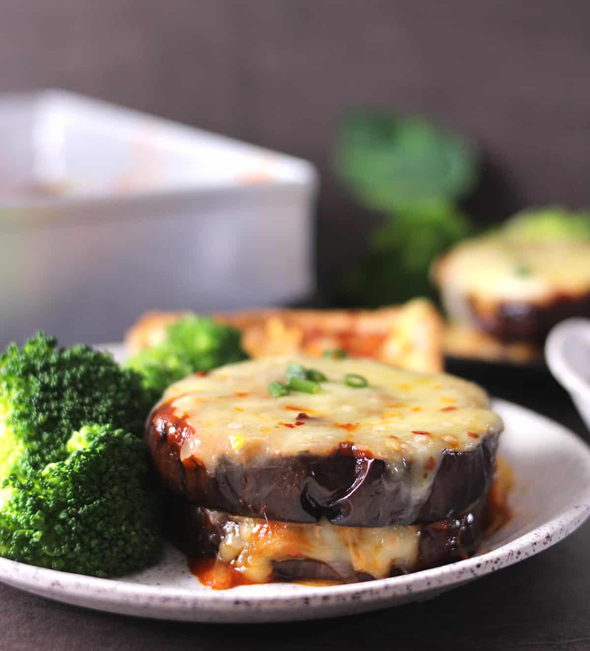 Cheesy eggplant served with steamed broccoli and bread toast, meal under 500 calories