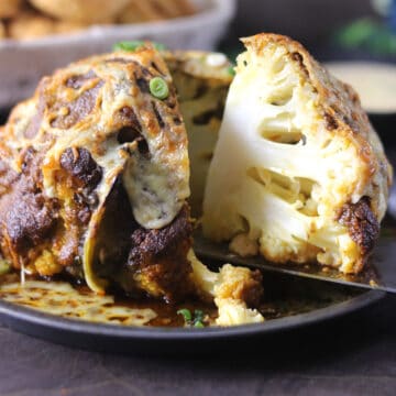 best, easy, spicy whole roasted cauliflower head with sauce for thanksgiving, Christmas dinner.