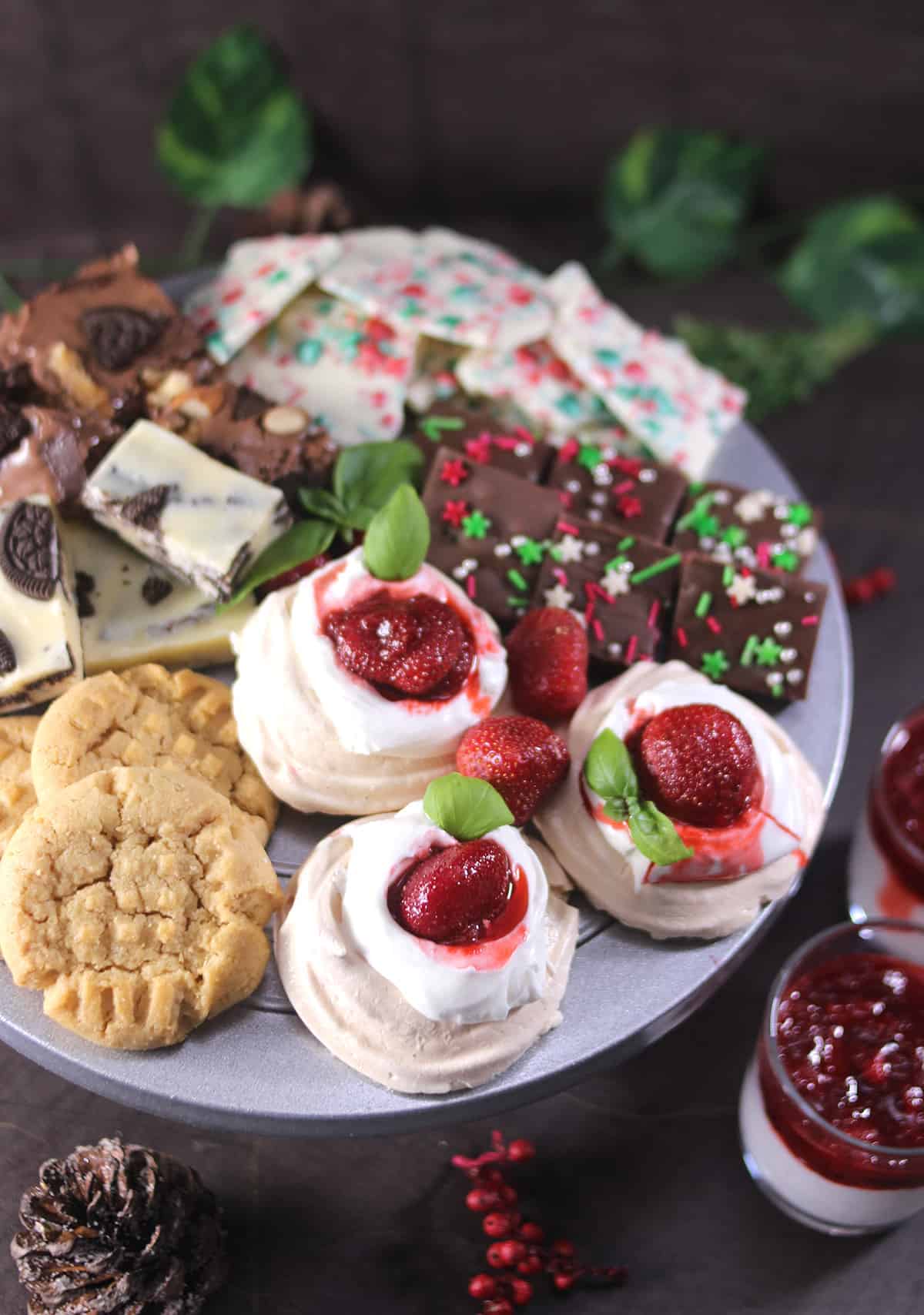 christmas dessert platter with pavlova, fudge, candy barks, cookies, brownies, marshmallow, dip
