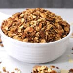 Easy Cinnamon Flavored Crispy Granola in a White Bowl.
