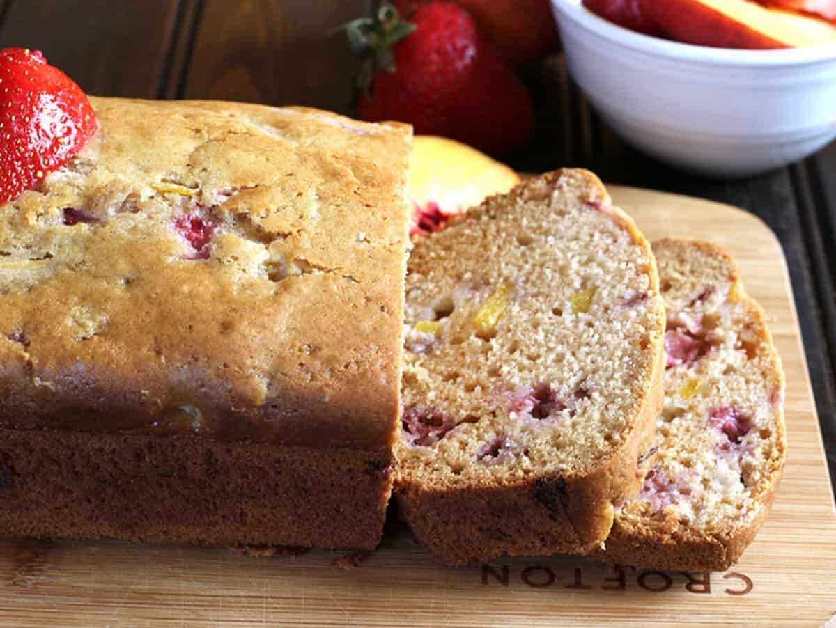 freshly slices of quick and healthy fruit bread on wooden board. 