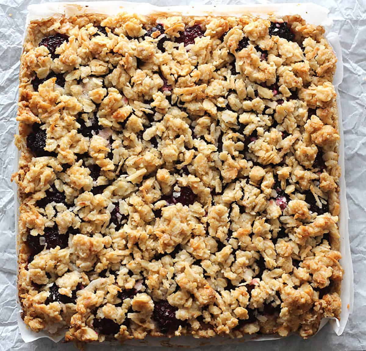 homemade blackberry oatmeal bars -unsliced - with golden brown crunchy topping just out of the oven!