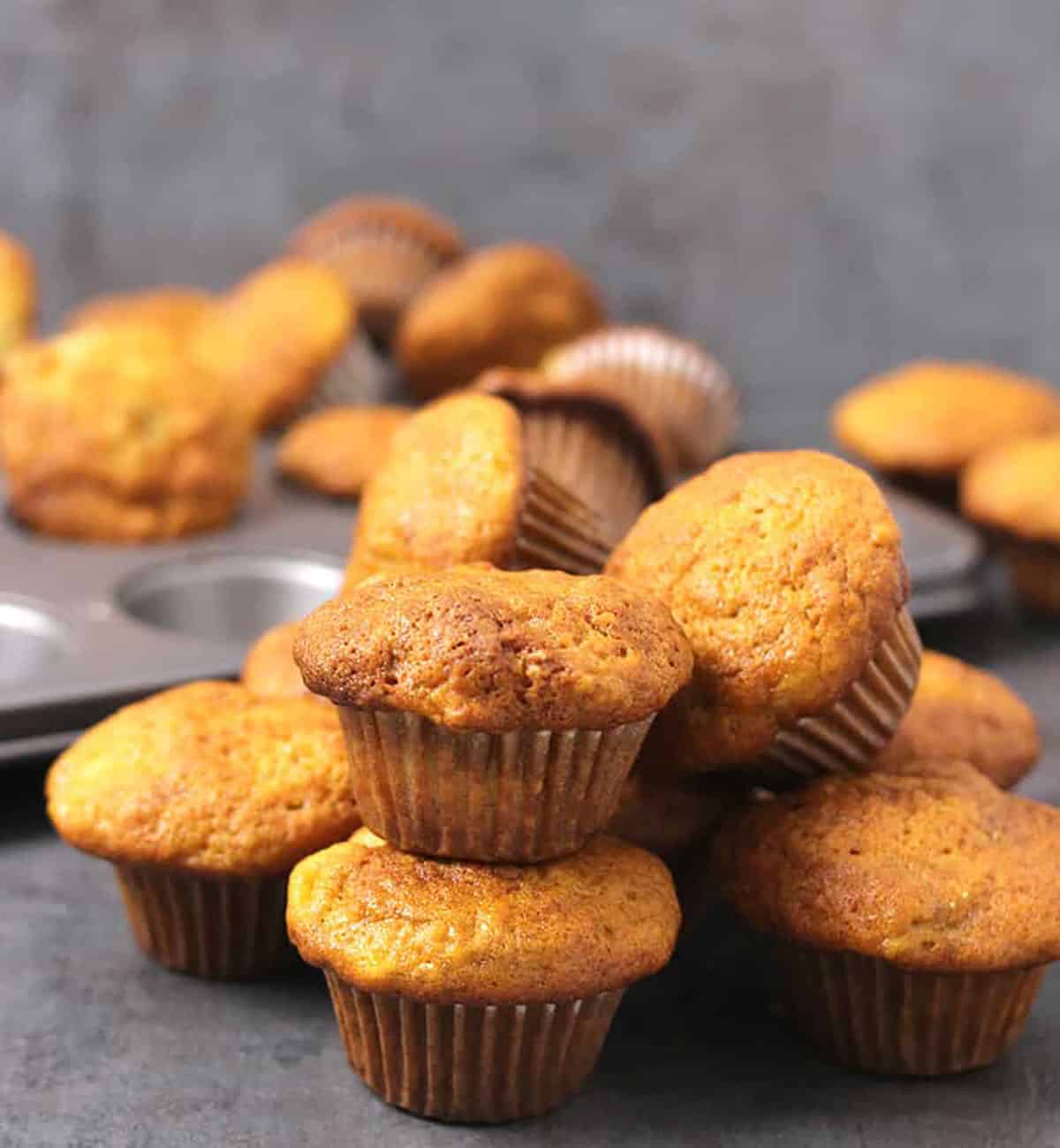 tastiest banana muffins baked to perfection are placed in a pile.